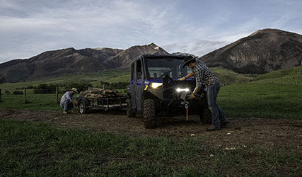 2 ranchers pulling a trailer with their Ranger Crew 1000