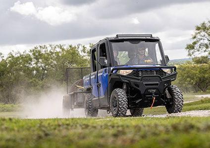 ranger crew sp 570 with ROPS-mounted side mirrors pulling a trailer