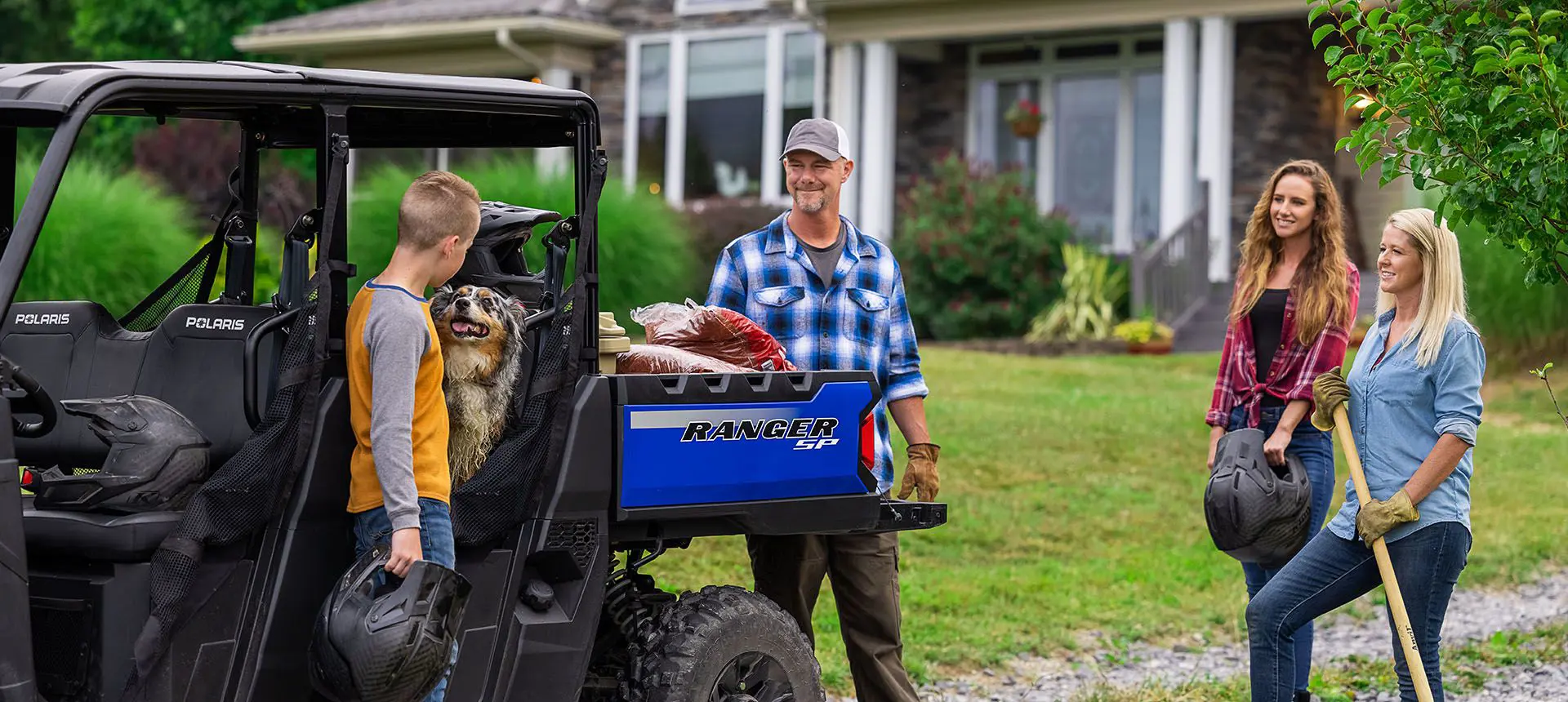 family using their ranger sp 570 to transport garden tools