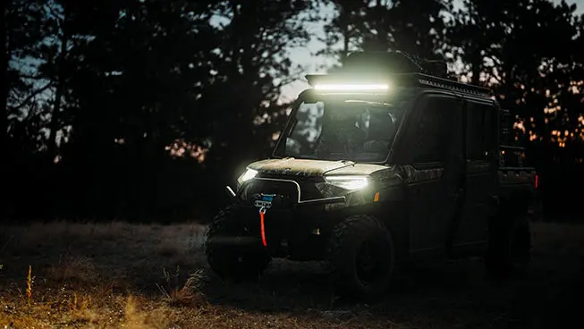 headlights and light bar illuminated on a polaris ranger crew xp 1000 northstar big game edition utv
