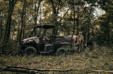 2 hunters walking away from their ultra-quiet polaris ranger ev