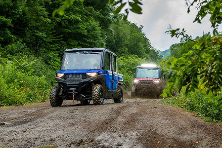 RANGER CREW SP 570 NorthStar Edition driving down a wet trail