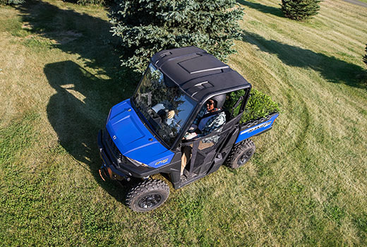 RZR 570 going down a green trail road