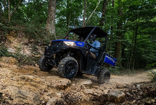 RZR 570 going down a green trail road