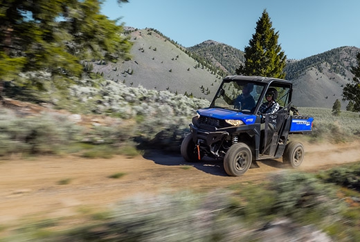RZR 570 going down a green trail road