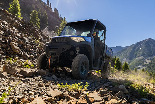 RZR 570 going down a green trail road
