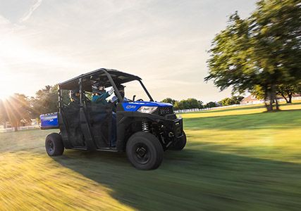 RANGER CREW SP 570 speeding through a green field