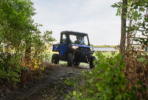 RZR 570 going down a green trail road