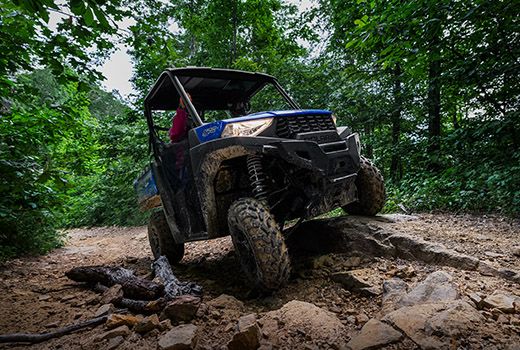 RZR 570 going down a green trail road
