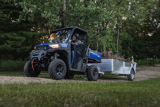 RZR 570 going down a green trail road