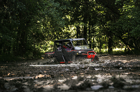 Polaris ranger crew xp 1000 high lifter in action in a mud hole