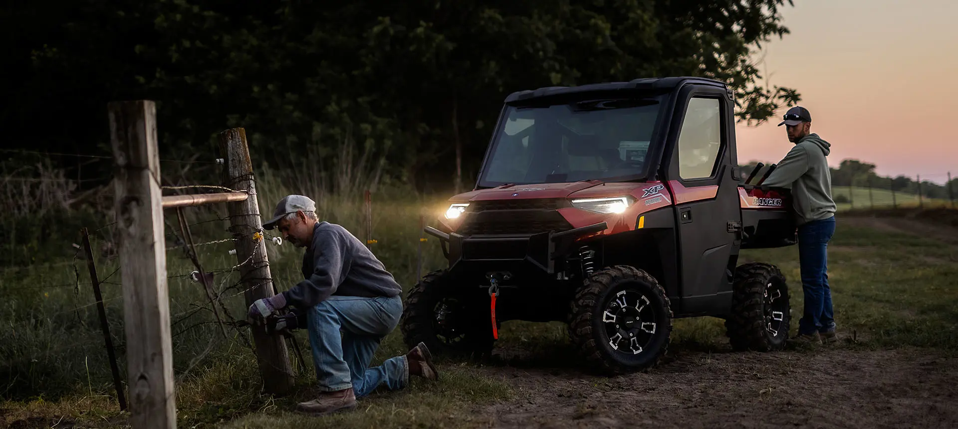 Man fixing fence with tools from cargo box of his Ranger XP 1000 NorthStar Edition