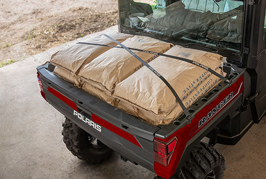 RZR 570 going down a green trail road