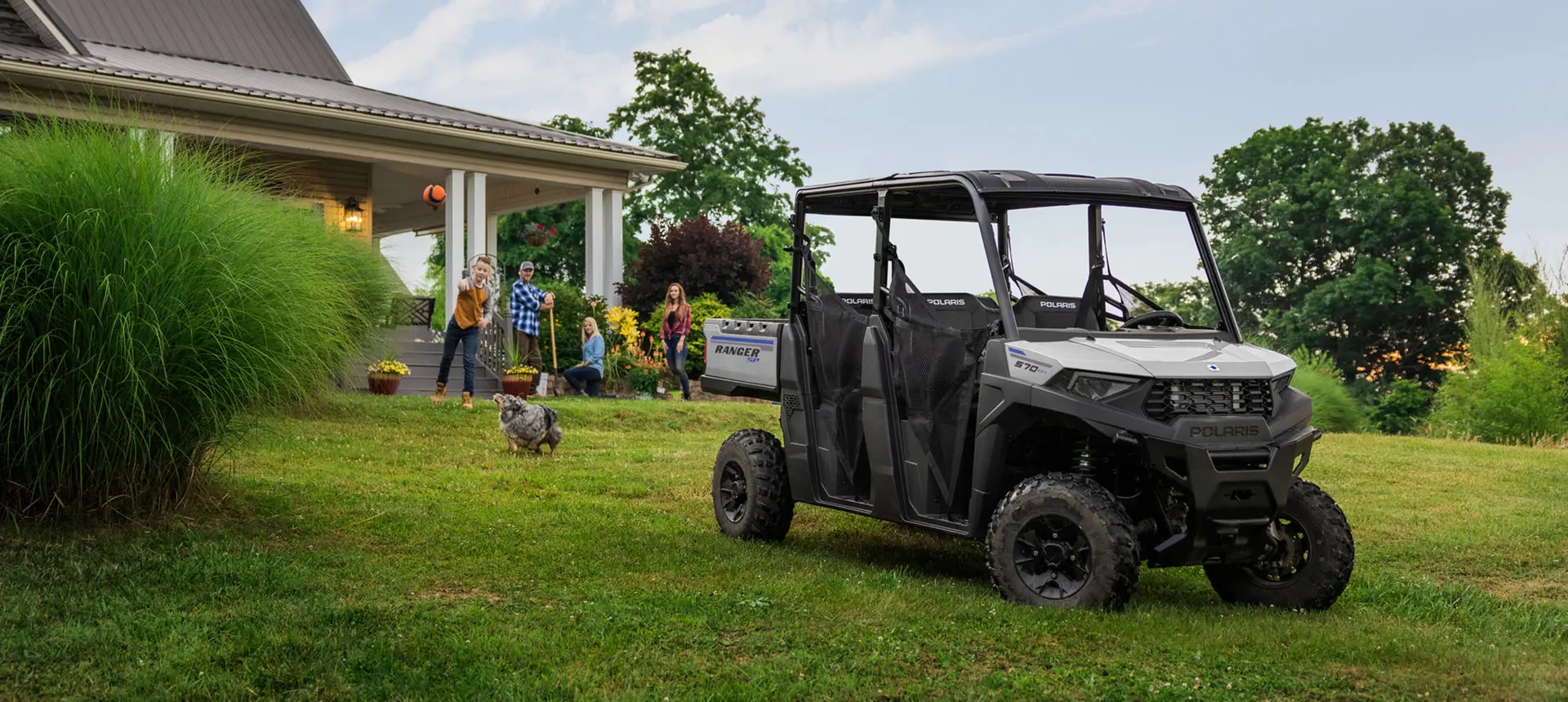 family playing near their ranger crew sp 570 utv