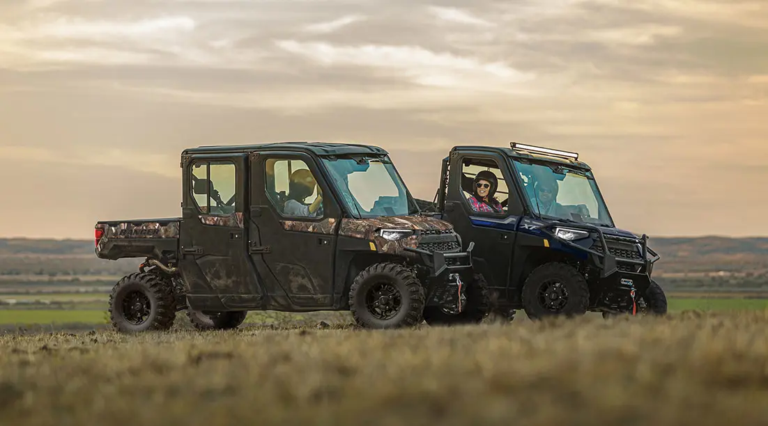 Ranger XP 1000 and Ranger Crew XP 1000 UTVs parked while owners chat