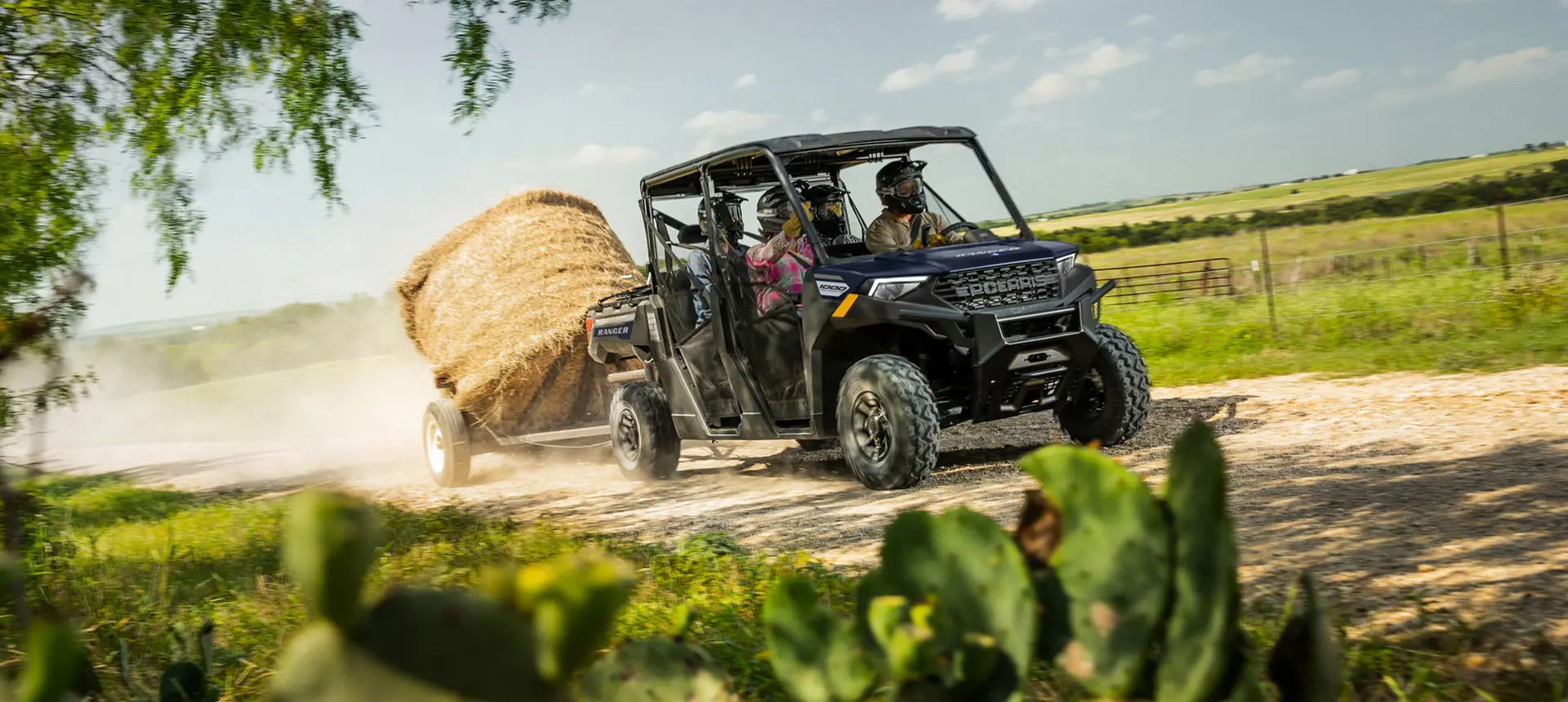Ranger Crew 1000 UTV pulling a trailer with a hay bale