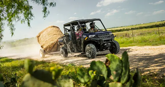 Ranger Crew 1000 UTV pulling a trailer with a hay bale