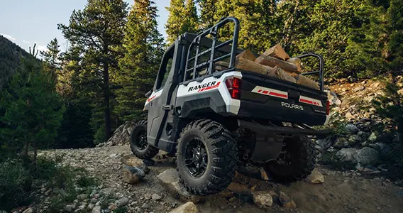 ranger xp 1000 northstar edition trail boss utv carrying wood over rocky terrain