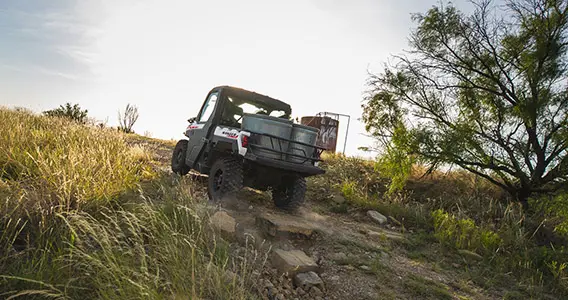 ranger xp 1000 northstar edition trail boss utv hauling water tubs on a farm