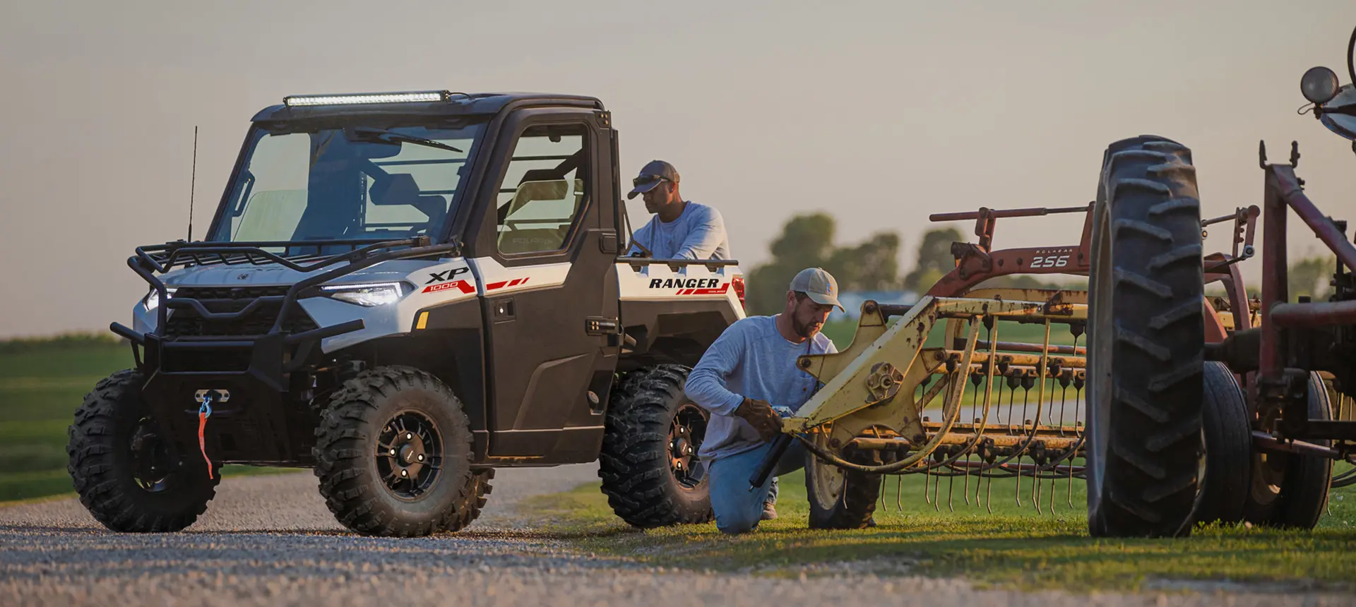 farmers fixing a rake using their ranger xp 1000 northstar edition trail boss utv