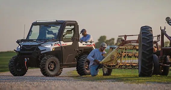 farmers fixing a rake using their ranger xp 1000 northstar edition trail boss utv