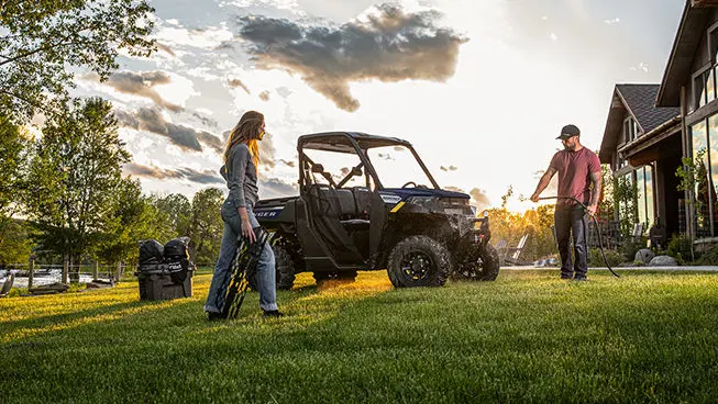 couple washing their ranger 1000 utv