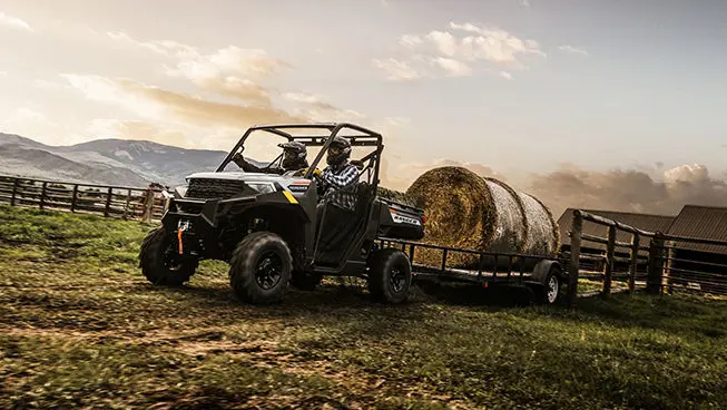 ranger 1000 utv pulling a heavy trailer with a hay bale on it