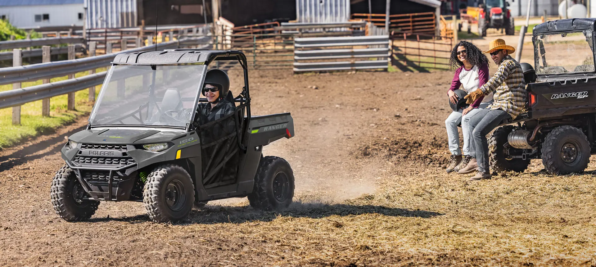 kid driving his RANGER 150 EFI UTV in a cow pasture as his parents watch