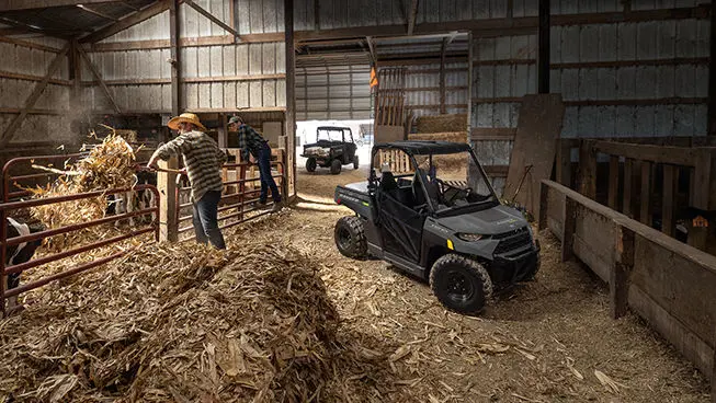 kid and dad feeding hay near a RANGER 150 EFI UTV