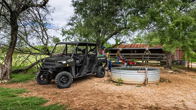 family using their ranger crew xp 1000 utv for hard work on the farm