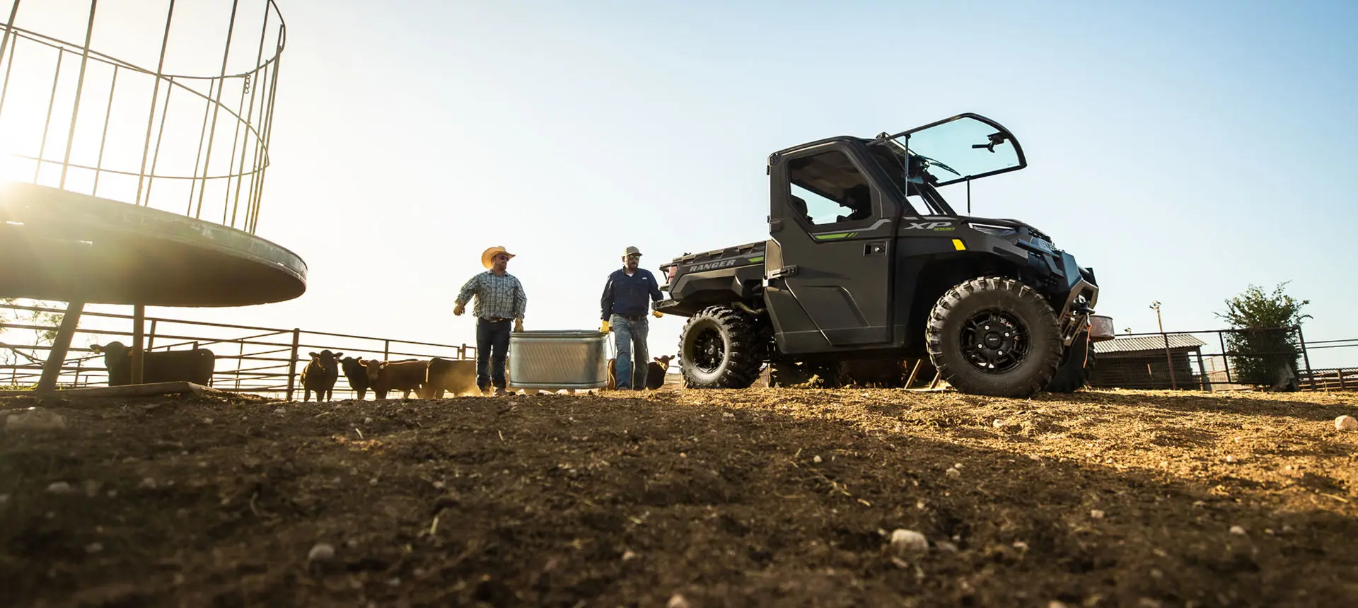 farmers walking with a feed bin towards their ranger xp 1000 northstar edition utv
