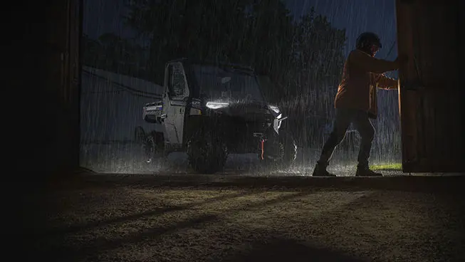 farmer opening the shed door in front of his ranger xp 1000 nortstar edition utv