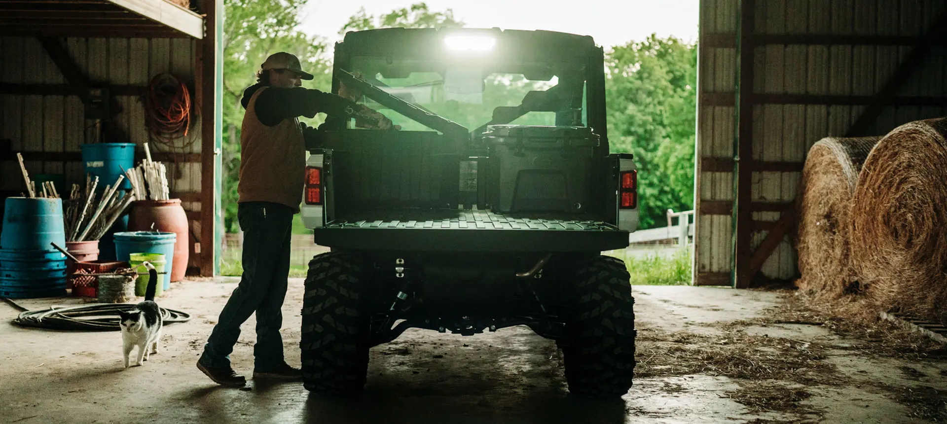farmer grabbing gear from the cargo box of their ranger xp 1000 northstar edition trail boss utv