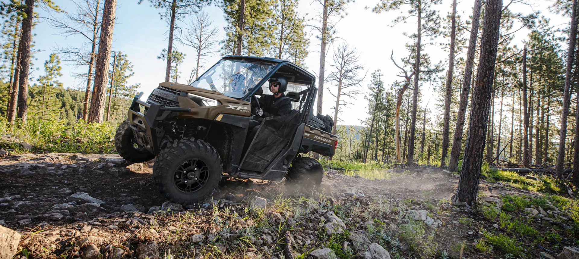 ranger xp 1000 driving on a forest trail