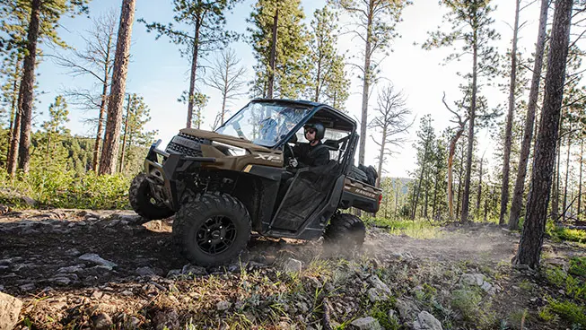 ranger xp 1000 driving on a forest trail