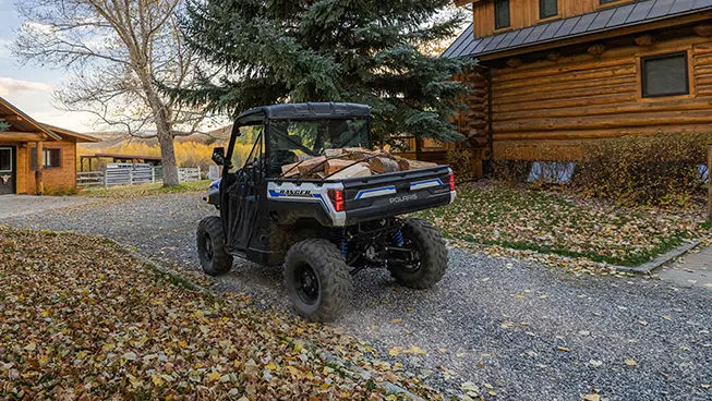 polaris ranger xp kinetic electric UTV hauling wood in the cargo box