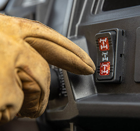 Finger touching the VersaTrac switch on a 2025 Polaris RANGER 570 Full-Size UTV.