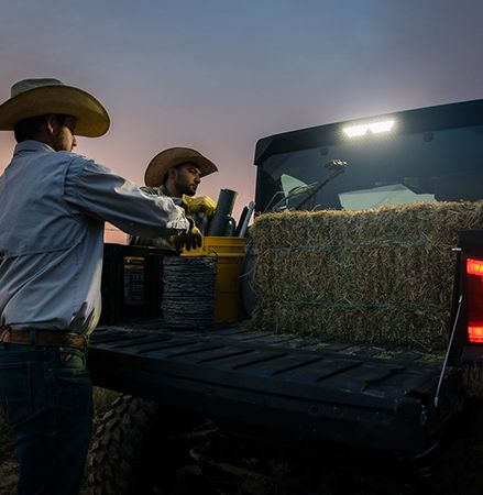 Ranchers using the rear work light over the cargo box on a 2025 Polaris RANGER XD 1500 NorthStar Edition extreme duty UTV.