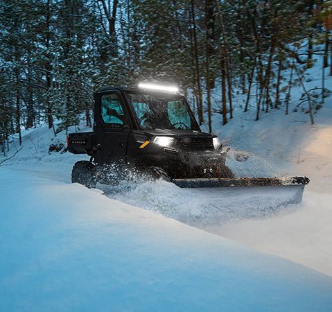 2025 Polaris RANGER 1000 UTV with a plow accessory plowing snow with ease due to the Gen 2 Transmission.