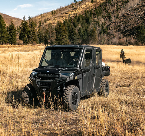 People sitting comfortably in the factory-installed Pro Shield cab system on a 2025 Polaris RANGER CREW XP 1000 NorthStar Texas Edition UTV.