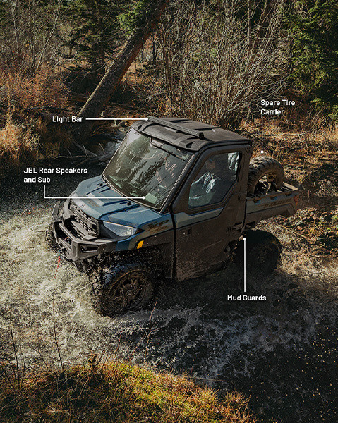 JBL rear speakers and sub, light bar, spare tire carrier and mud guard accessories from the Trail-Riding package installed on a 2025 Polaris RANGER XP 1000 NorthStar Edition UTV. 