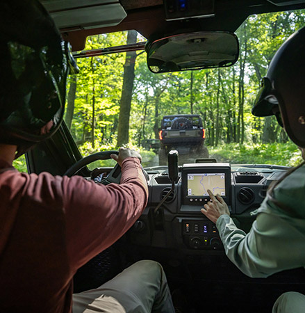 Riders using the RIDE COMMAND touch screen in a 2025 Polaris RANGER XP 1000 NorthStar Trail Boss Edition UTV.