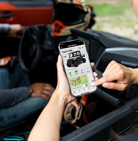 Person using the RIDE COMMAND Plus features for their 2025 Polaris RANGER XP 1000 NorthStar Trail Boss Edition UTV.