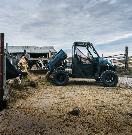 Person dumping silage out of the cargo box of their 2025 Polaris RANGER XP 1000 UTV.