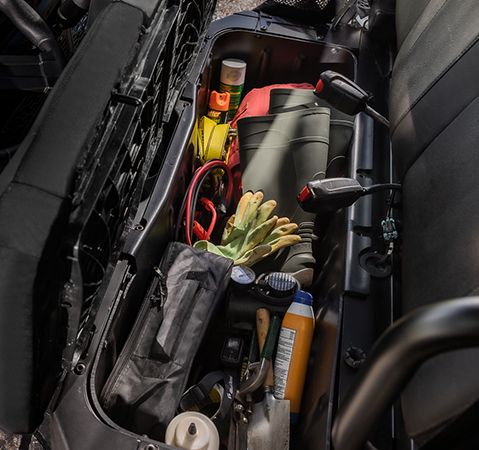 Underseat storage bin in the enclosed cab of a 2026 Polaris RANGER SP 570 NorthStar Edition UTV.