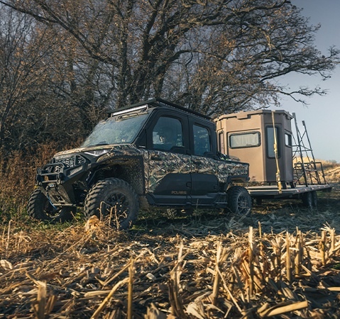 A 2026 Polaris RANGER XD 1500 NorthStar Edition extreme duty UTV pulling a trailer carrying a deer blind.