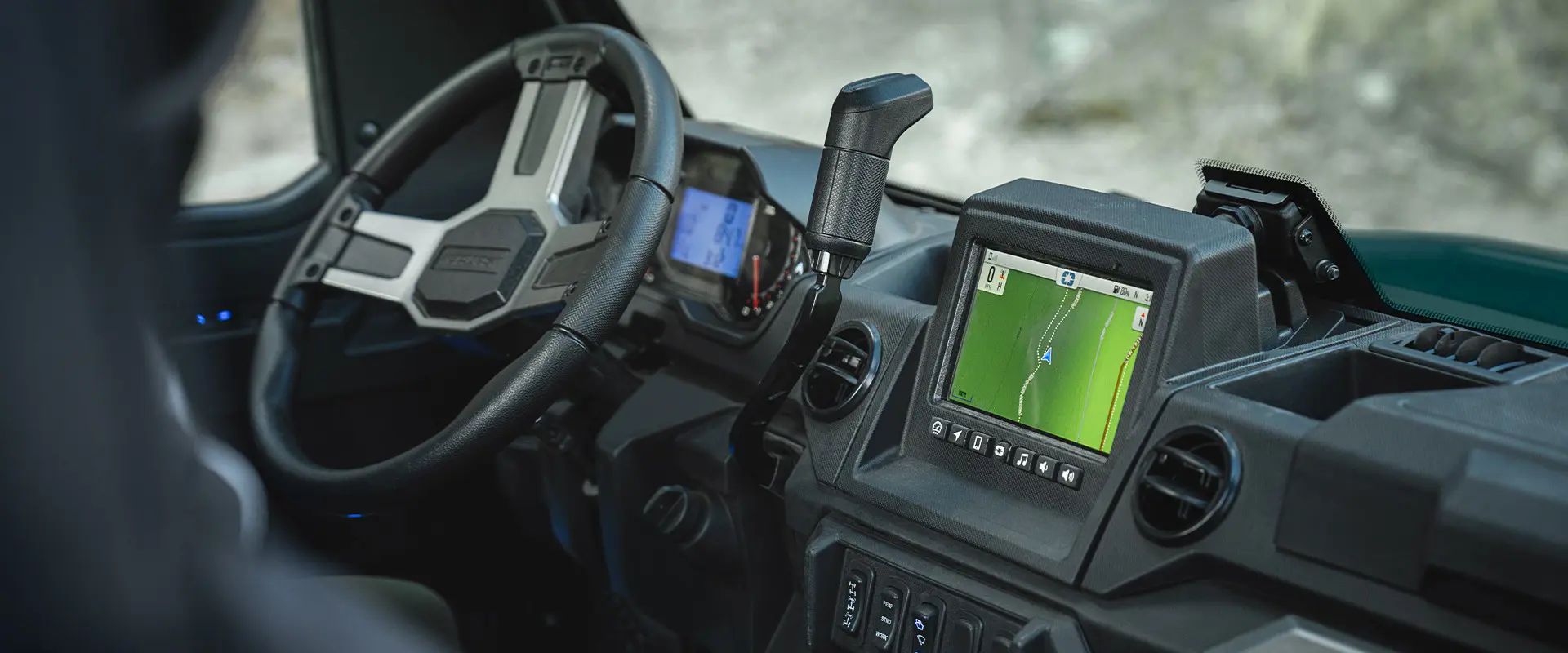 Interior view of the enclosed cab and amenities of a 2026 Polaris RANGER XP 1000 NorthStar Edition utility vehicle.