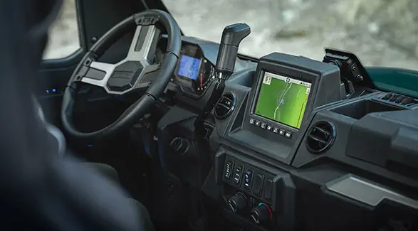Interior view of the enclosed cab and amenities of a 2026 Polaris RANGER XP 1000 NorthStar Edition utility vehicle.