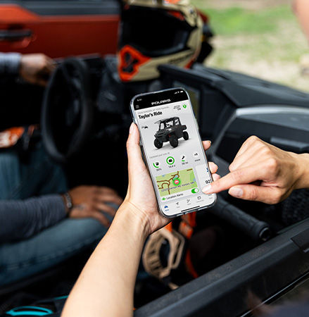 A person using the RIDE COMMAND app to track their ride in their 2026 Polaris RANGER XP 1000 NorthStar Trail Boss Edition UTV.