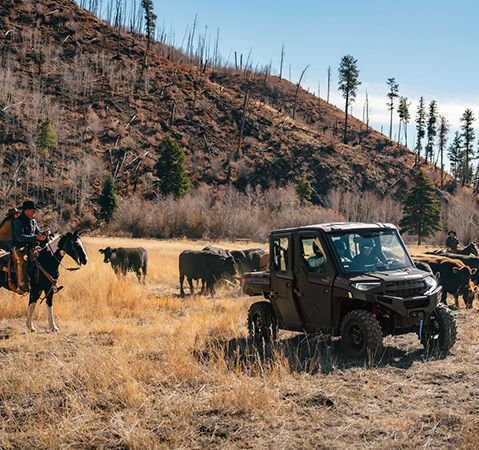 4 people in a 2026 Polaris RANGER XP 1000 NorthStar Trail Boss Edition UTV enjoying the air conditioning on a hot day. 